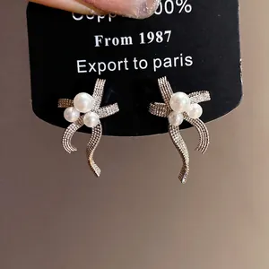 Elegant silver needle bow-knot earrings featuring three lustrous pearls for women
