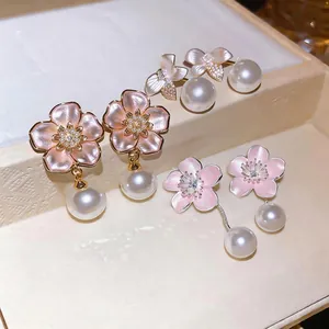 Elegant pink cherry blossom stud earrings with pearls and delicate enamel flower design