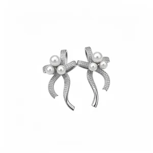 Elegant silver needle bow-knot stud earrings with pavé stones and white pearls for women