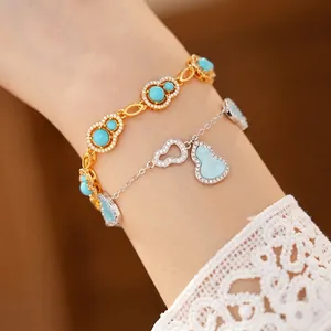 Exquisite blue zircon hollow gourd bracelets in gold and silver plating on wrist.