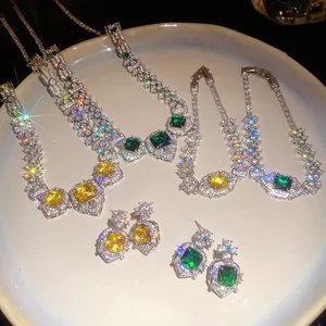 Detailed view of luxurious square emerald and citrine jewelry sets on white plate