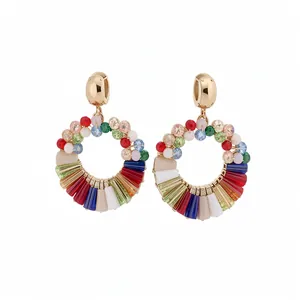 Vibrant colorful crystal hoop earrings with gold-toned round studs and rainbow stones.