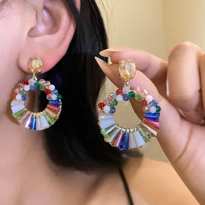 Close-up detail of colorful crystal wreath earrings featuring elegant silver needle studs