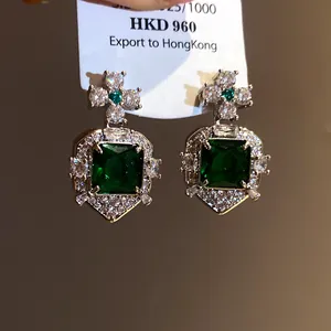 Detailed view of elegant square green zircon earrings with vintage silver setting