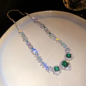 Detailed macro view of a luxury palace-style necklace with emerald green stones