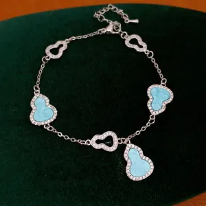 Elegant silver-toned zircon hulu bracelet detail featuring turquoise blue gourd charms