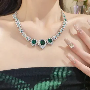 Detail shot of luxury emerald green zircon court style necklace on female model.
