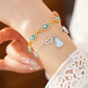 Detailed view of elegant gold and silver hollow gourd bracelets with blue zircon stones