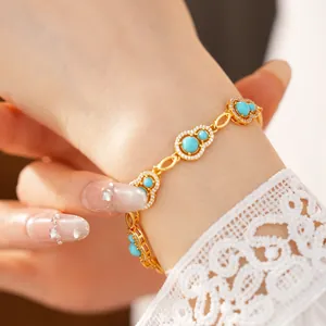 Detailed view of elegant gold bracelet featuring turquoise calabash charms and pavé zircons