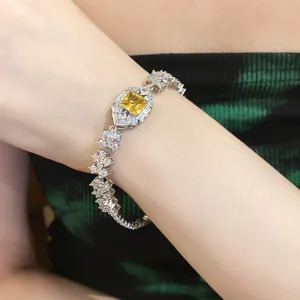 Detailed view of an elegant vintage silver bracelet with square yellow zircon.