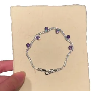 Elegant silver tennis bracelet with purple round stones and sparkling zircons.