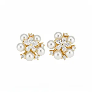 Exquisite floral stud earrings featuring white pearls and sparkling cubic zirconia stones.