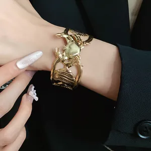 Detailed macro view of vintage gold metallic crab and seashell hollow-out cuff bracelet