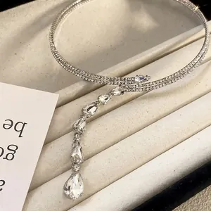 Close-up of elegant double-layer silver choker with sparkling teardrop zircon stones