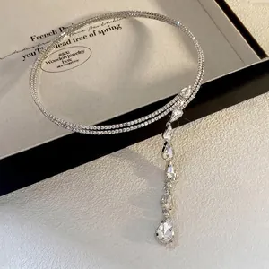 Close-up of double-layered rhinestone necklace with cascading teardrop crystal