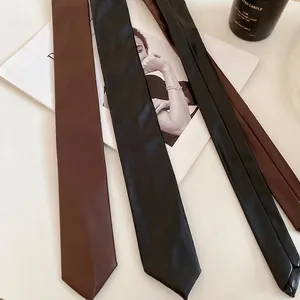 Vintage style black and brown leather tie necklaces on a minimalist white background