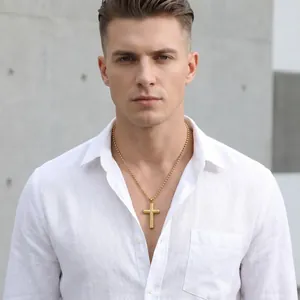 Close-up of gold stainless steel cross necklace with diagonal pattern on male model