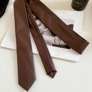 Detail view of brown faux leather tie necklace accessory on vintage fashion magazine background