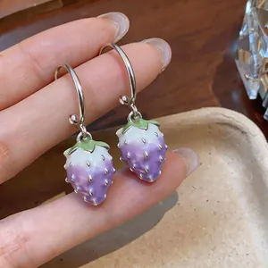 Close-up of sweet purple enamel strawberry dangle earrings with silver-tone hoops