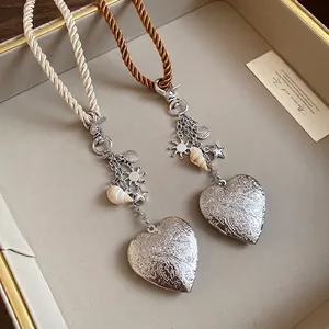 Vintage silver heart locket necklace with seashell charms and braided rope cord for women