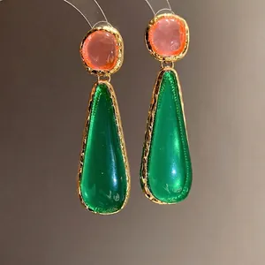 Vintage resin teardrop earrings with green and orange stones in gold hammered frames