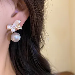 Elegant pearl earrings with white shell flower design and sparkling stones detail