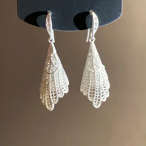 Elegant silver-toned hollow lace drop earrings with sparkling zircon-set ear hooks