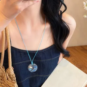 Summer beach style necklace with real conch shells and blue cord for vacation photos