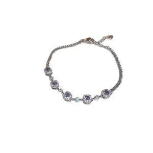Sparkling silver charm bracelet featuring round purple zircons and crystal halos