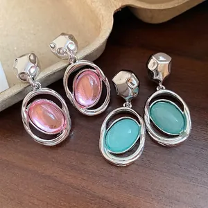 Vintage acrylic oval pendant earrings with silver needle and chic metallic accents.