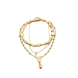 Layered gold necklace set with irregular nugget beads and water drop pendant