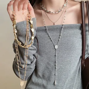 Detail shot of four-piece irregular water drop pendant necklace set in silver and gold.