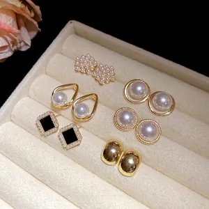 Elegant vintage pearl earring set with gold-plated studs displayed in a velvet jewelry box