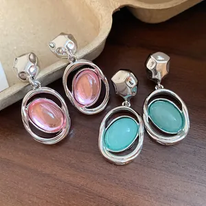 Detailed view of elegant retro oval acrylic pendant earrings with silver needle posts