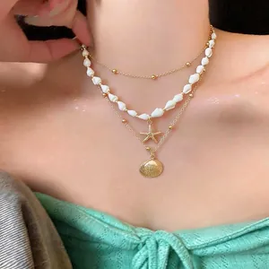 Élégant collier de plage à trois rangs avec pendentifs étoile de mer et coquillage