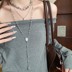 Detail of layered four-piece necklace set with irregular teardrop pendants and bead chain