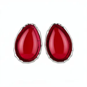 Red resin water drop stud earrings with silver-colored irregular metallic frame design