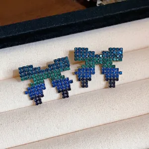 Elegant pixel bow stud earrings with gradient blue and green rhinestones in jewelry box