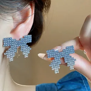 Pixelated bow earrings with blue gradient rhinestones on silver needle