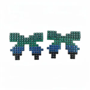 Pixel art bow stud earrings with green and blue crystal pave in silver setting