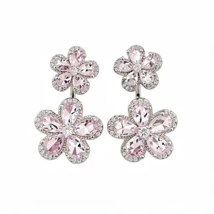 Elegant pink zircon flower stud earrings with a silver-tone finish on a white background.
