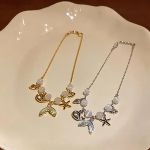 Elegant mermaid tail and starfish bracelet with cat eye stones in gold and silver finish