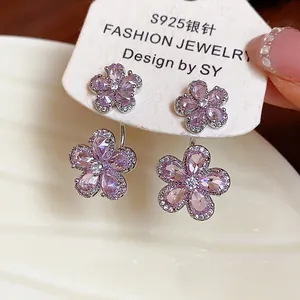 Macro detail of elegant pink zircon flower earrings on S925 silver stud display card