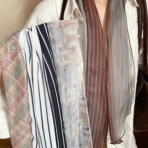 Detailed view of sheer mesh scarves with various stripes and floral patterns