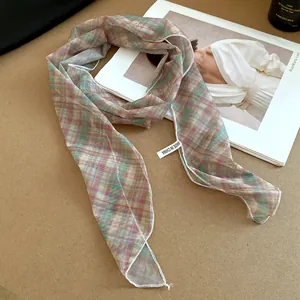 Detailed view of a lightweight colorful mesh plaid scarf featuring an elegant sheer texture.