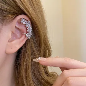 Elegant silver flower ear cuff earring with sparkling zircons for non-pierced ears on model