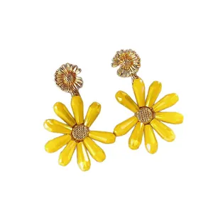 Vibrant yellow daisy dangle earrings with faceted petals and gold accents.