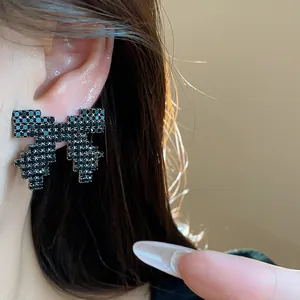 Elegant black rhinestone bow stud earrings showing detailed sparkle and silver needle post