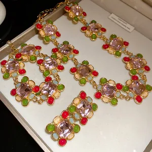 Close-up of vintage French style jewelry set with pink crystals and resin beads