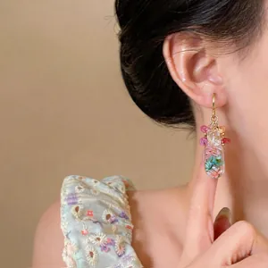 Close-up detail of elegant new Chinese style resin flower drop earrings on model